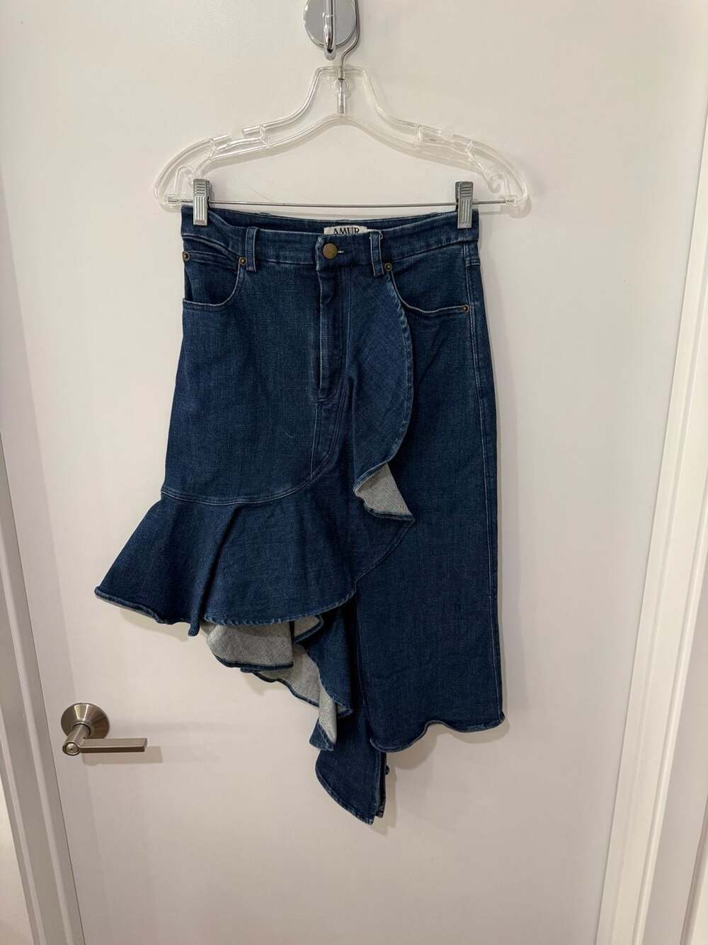 AMUR Kiara skirt denim and features an asymmetrical ruffle skirt.